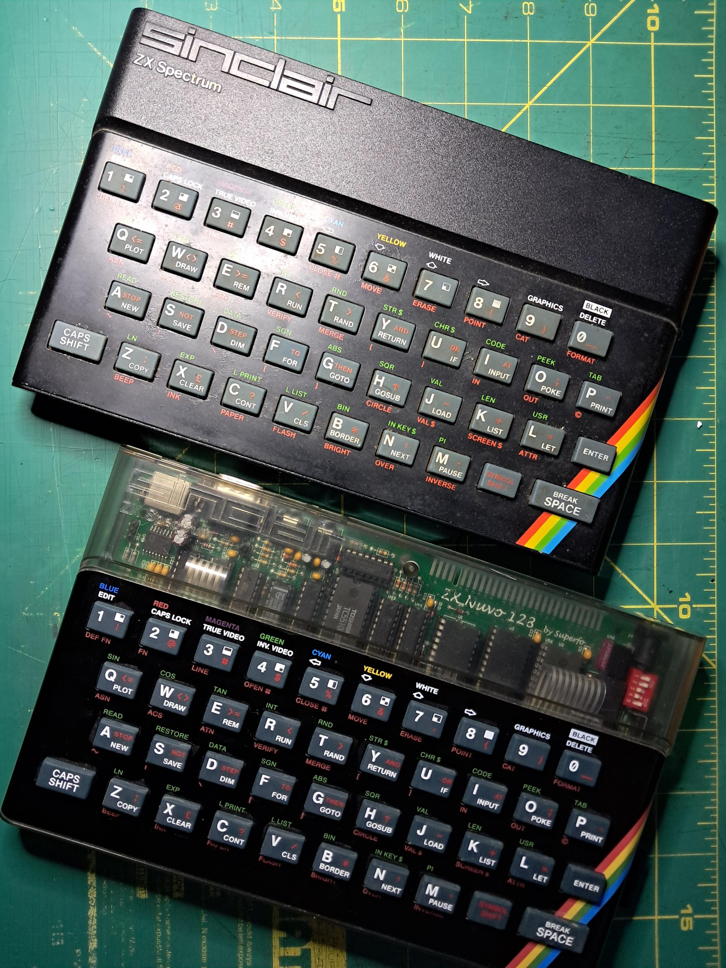 Top: an original 16kB Sinclair ZX Spectrum. Bottom: a kit built ZX Nuvo/ Harlequin in an aftermarket translucent Spectrum case with a reproduction keyboard and top plate.