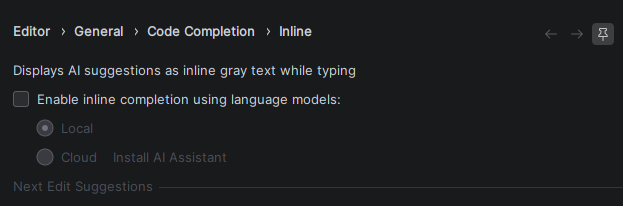 A configuration setting, now unticked, reading "Display AI suggestions as inline gray text while typing." With the options to choose from Local or Cloud grayed out.