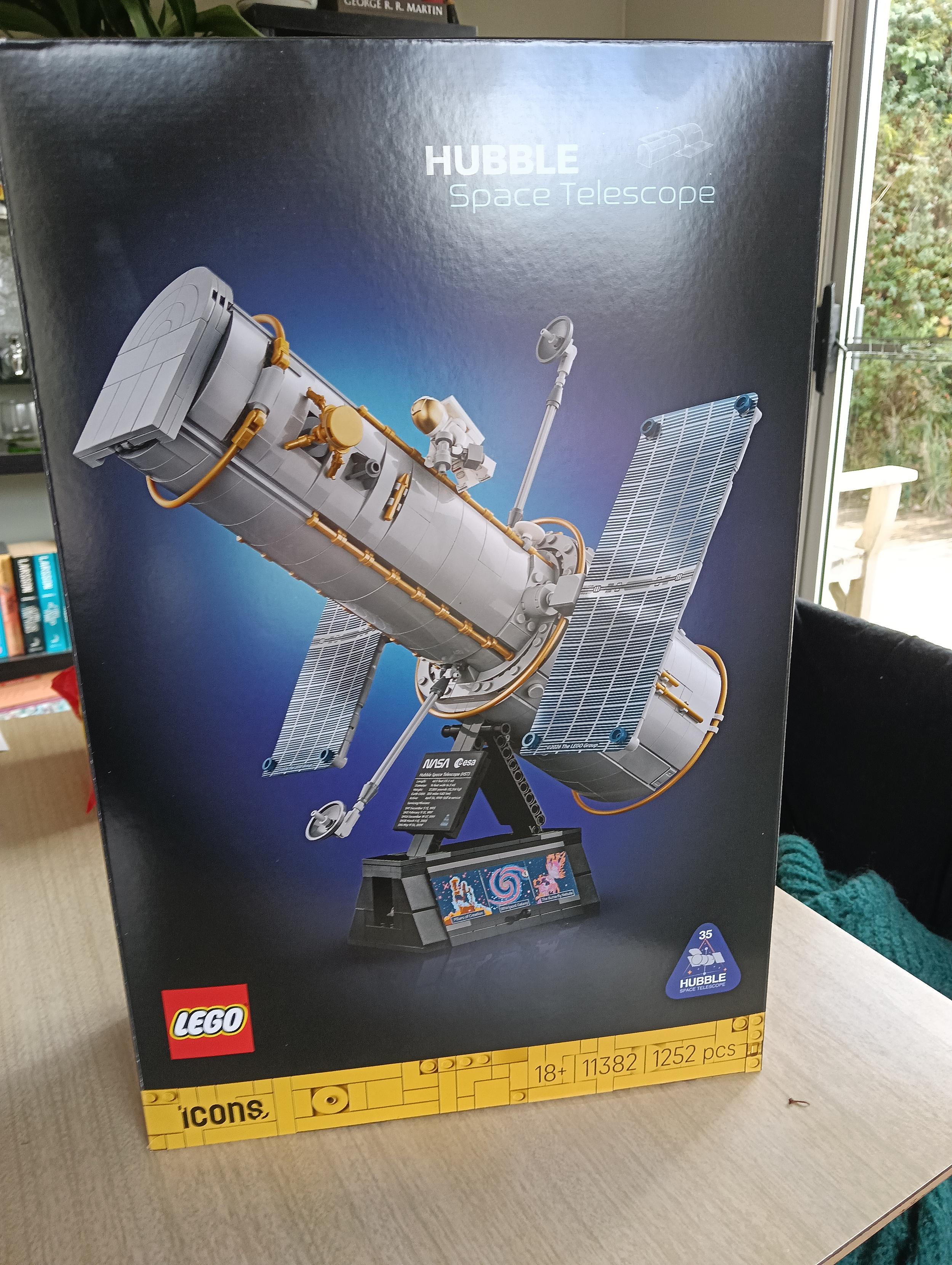 A blue box with the Lego logo and a Lego build Hubble space telescope image