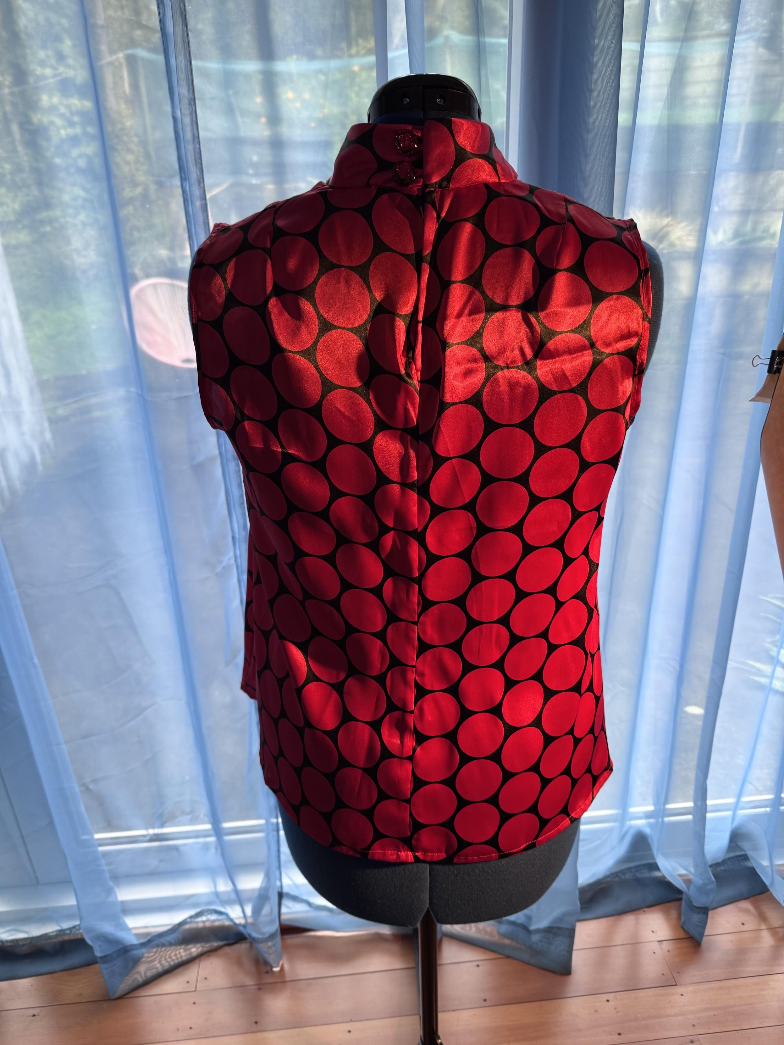 Provided by @altbot, generated privately and locally using Gemma4:26b

@ygathgoch A sleeveless, shiny red top with large dark polka dots is displayed on a black mannequin. The fabric has a satin-like sheen and features a pattern of large, dark circular dots across its entire surface. The garment has a high neckline and a vertical seam running down the center back. It is positioned in front of light blue, sheer curtains that are backlit by bright daylight. A portion of a wooden floor is visible at the bottom of the frame.
―
A close-up photograph of red and black patterned fabric featuring two large, glittery buttons. The fabric has wide, wavy black shapes over a deep red base with a slight sheen. Two circular, translucent buttons are arranged vertically, each containing bright pinkish-red glitter inside.
―
A sleeveless, high-necked top is displayed on a black mannequin. The garment is red with large, black polka dots arranged in a pattern across its entire surface. Behind the mannequin, sheer light blue curtains hang in front of a window, casting sunlight and shadows across the top. A small portion of a wooden floor is visible at the bottom of the image.

🌱 Energy used: 0.888 Wh